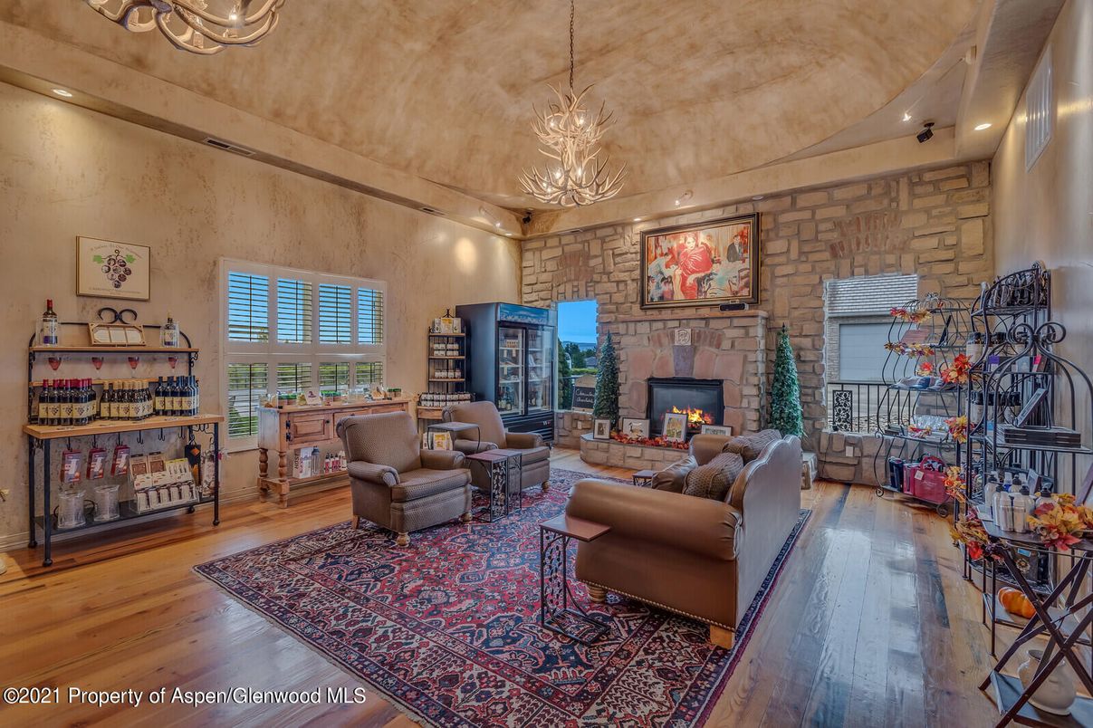 Chandelier, Fireplace, Interior, Living room, Recessed Lighting, Stone Walls, Wood Texture Flooring