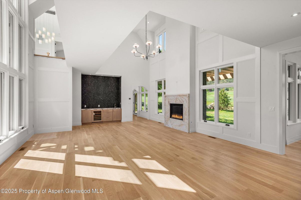 Chandelier, Empty room, Fireplace, Interior, Pendant Lights, Recessed Lighting, Wood Texture Flooring