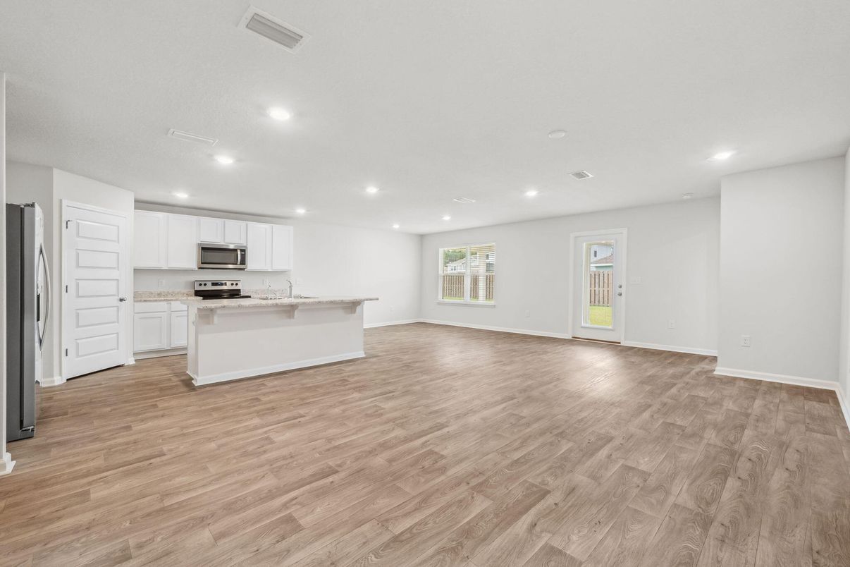 Empty room, Interior, Kitchen, Recessed Lighting, Stainless Steel Appliances, Wood Texture Flooring