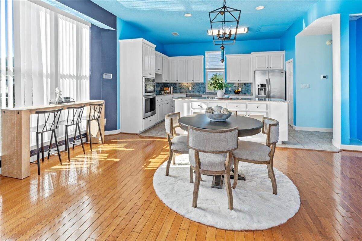 Chandelier, Dining room, Interior, Kitchen, Pendant Lights, Recessed Lighting, Stainless Steel Appliances, Wood Texture Flooring
