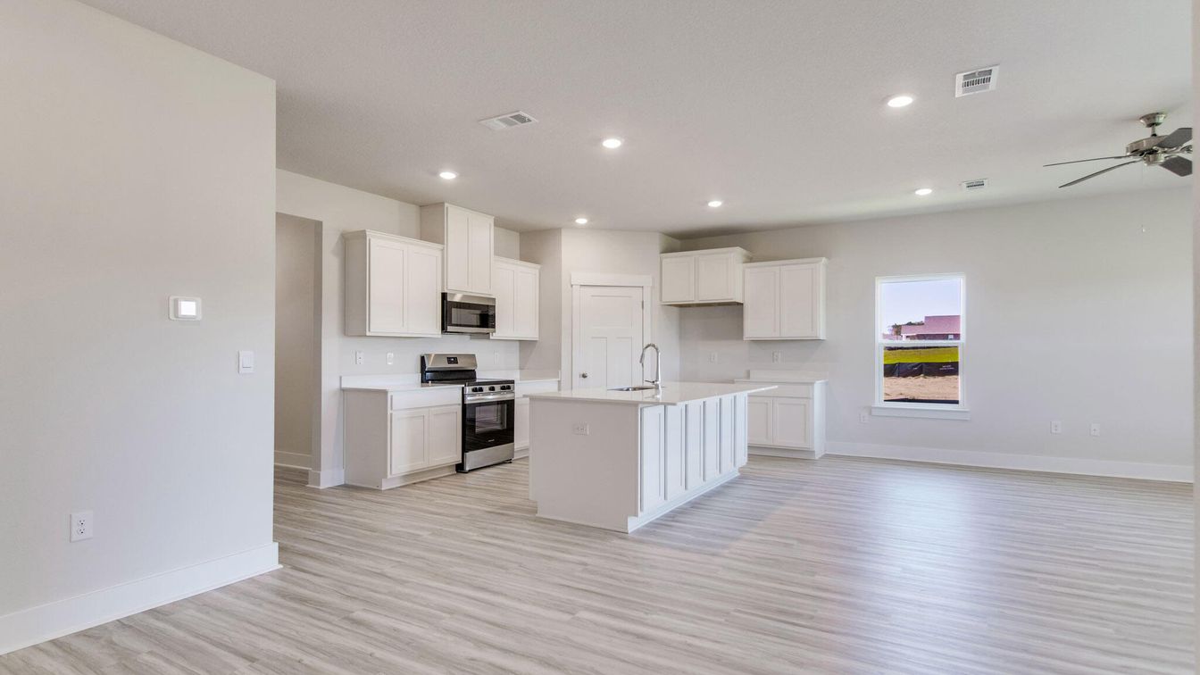Empty room, Interior, Kitchen, Recessed Lighting, Stainless Steel Appliances, Wood Texture Flooring