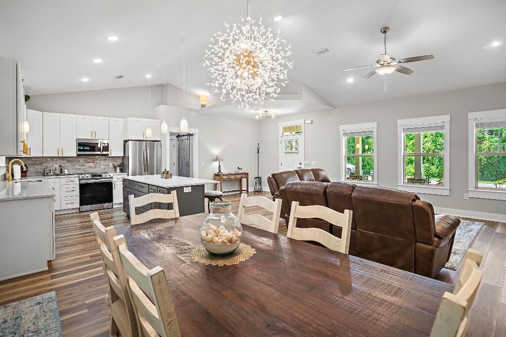 Chandelier, Dining room, Interior, Kitchen, Living room, Pendant Lights, Recessed Lighting, Stainless Steel Appliances, Wood Texture Flooring