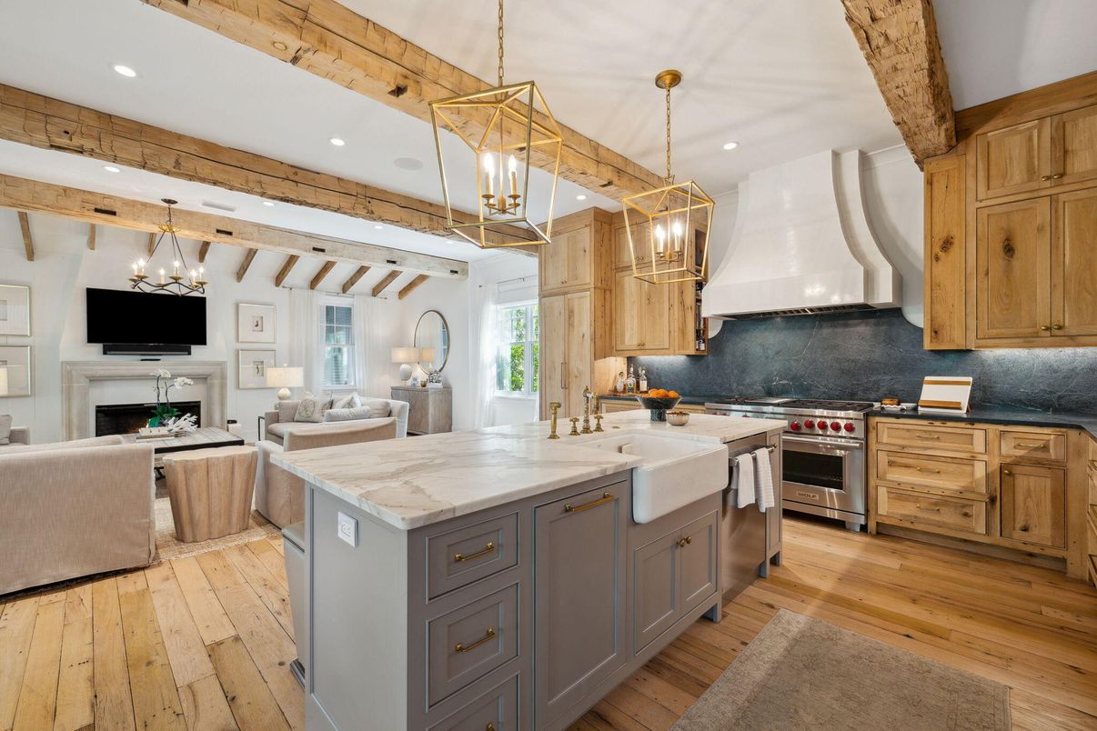 Chandelier, Fireplace, Interior, Kitchen, Living room, Pendant Lights, Recessed Lighting, Stainless Steel Appliances, Wooden Beams, Wood Texture Flooring