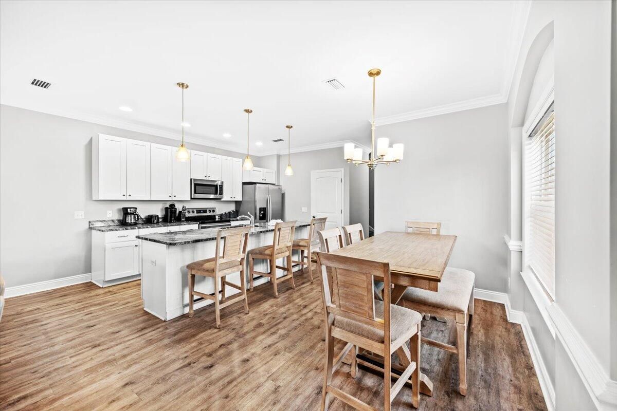 Chandelier, Dining room, Interior, Kitchen, Pendant Lights, Recessed Lighting, Stainless Steel Appliances, Wood Texture Flooring