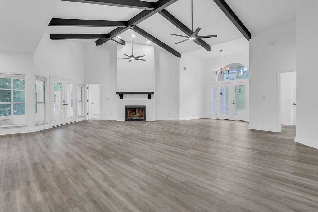 Chandelier, Empty room, Fireplace, Interior, Recessed Lighting, Wooden Beams, Wood Texture Flooring