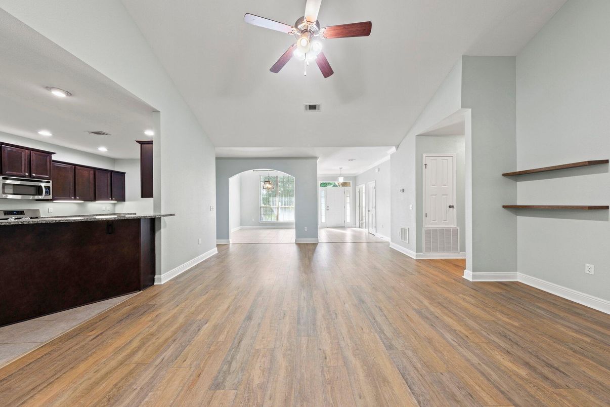 Empty room, Interior, Kitchen, Recessed Lighting, Stainless Steel Appliances, Wood Texture Flooring