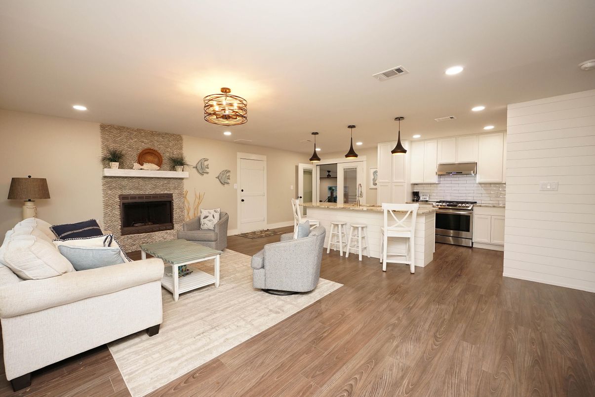 Fireplace, Interior, Kitchen, Living room, Pendant Lights, Recessed Lighting, Stainless Steel Appliances, Stone Walls, Wood Texture Flooring