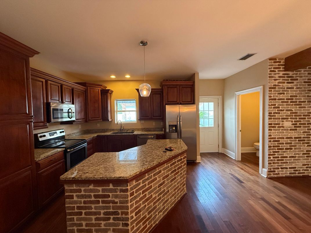 Interior, Kitchen, Pendant Lights, Recessed Lighting, Stainless Steel Appliances, Stone Walls, Wood Texture Flooring