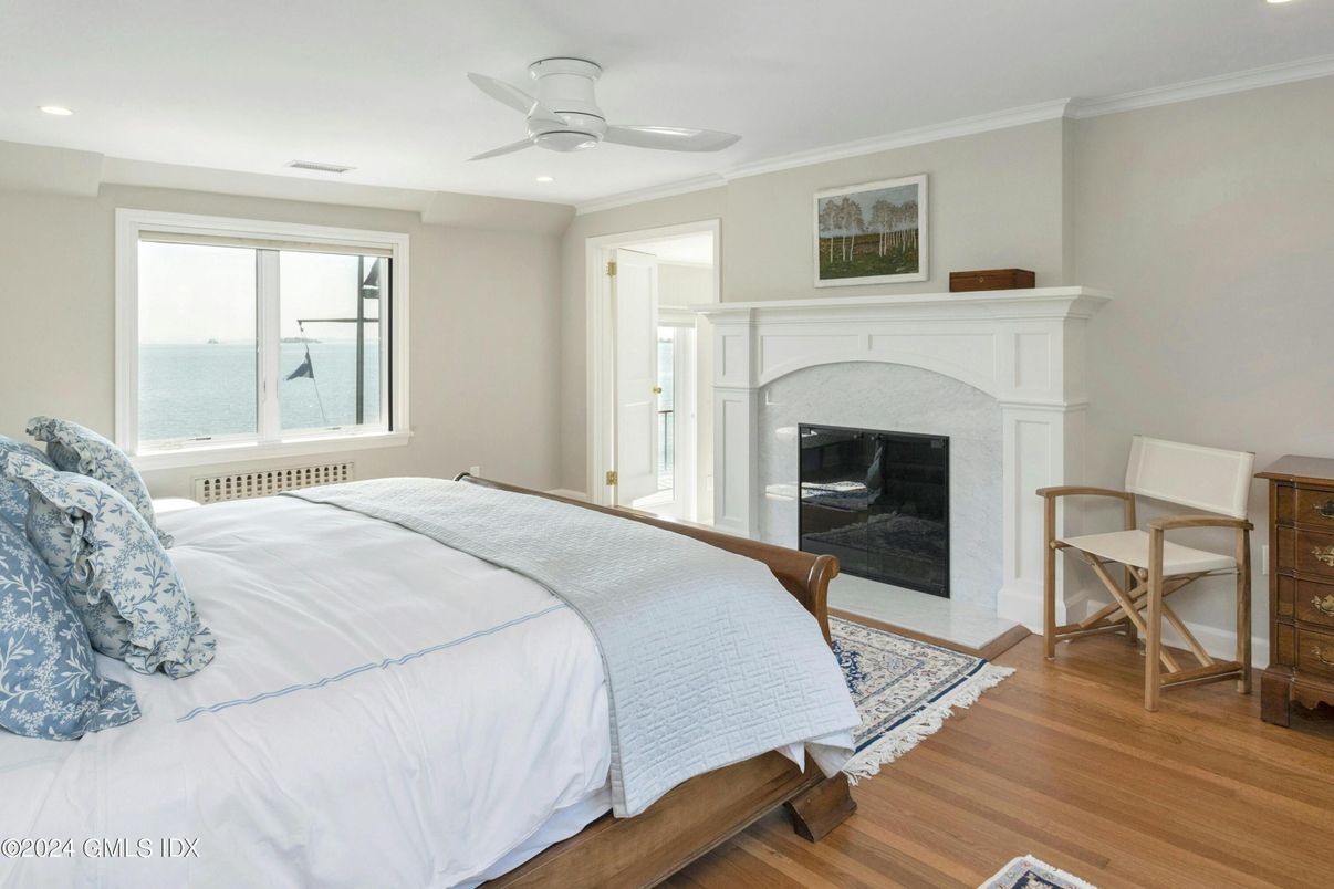 Bedroom, Fireplace, Interior, Recessed Lighting, Water, Wood Texture Flooring