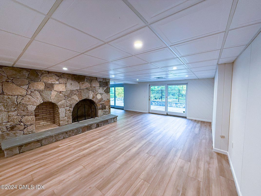 Empty room, Fireplace, Interior, Recessed Lighting, Stone Walls, Wood Texture Flooring
