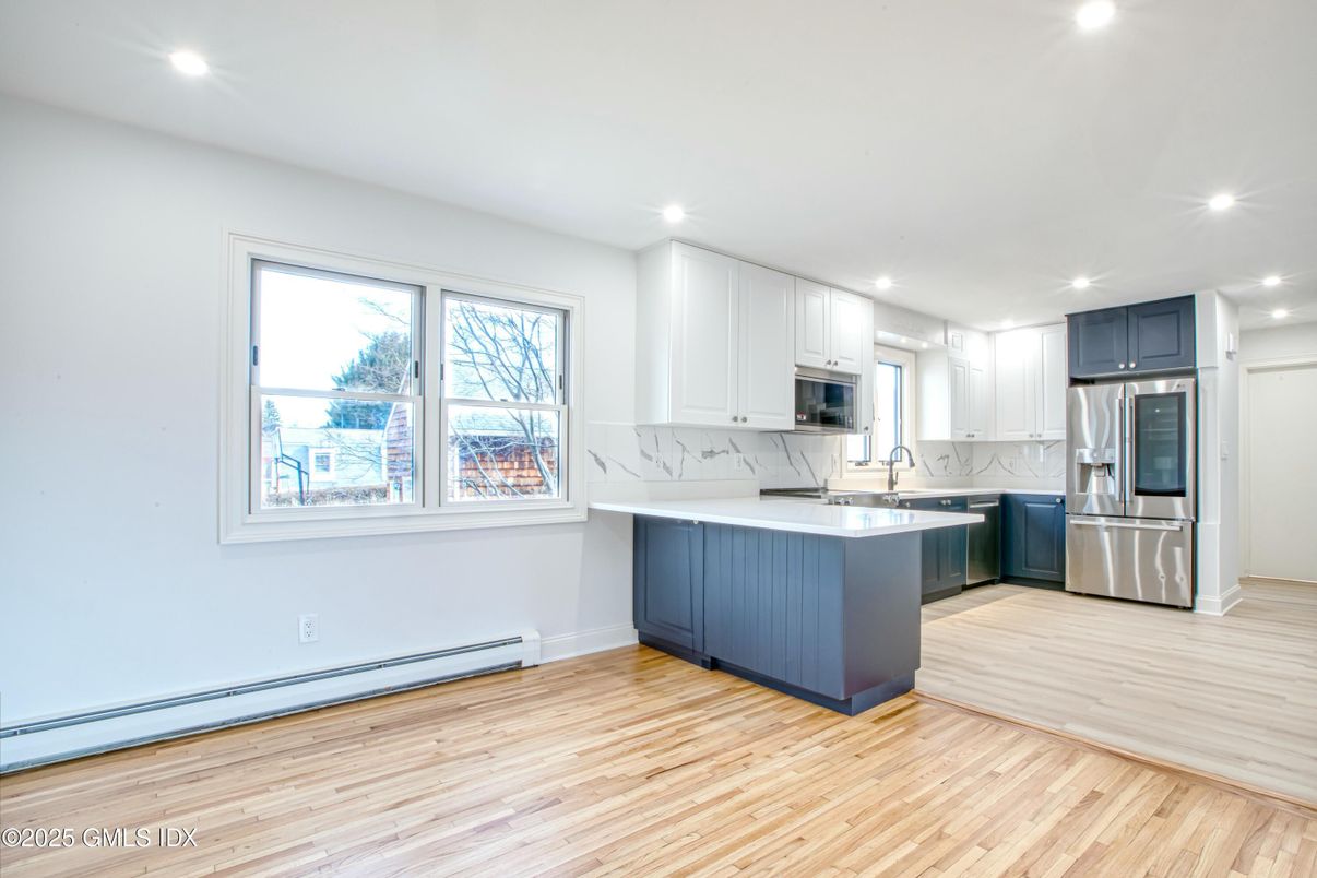 Interior, Kitchen, Marble Walls, Recessed Lighting, Stainless Steel Appliances, Wood Texture Flooring