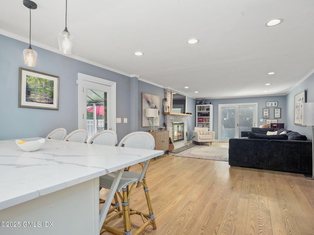 Dining room, Fireplace, Interior, Living room, Pendant Lights, Recessed Lighting, Wood Texture Flooring