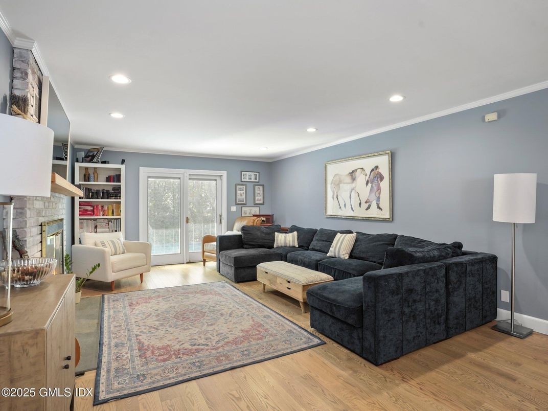 Fireplace, Interior, Living room, Recessed Lighting, Stone Walls, Wood Texture Flooring