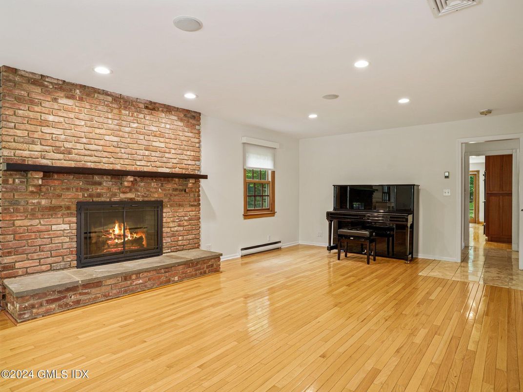 Fireplace, Interior, Piano, Recessed Lighting, Stone Walls, Wood Texture Flooring