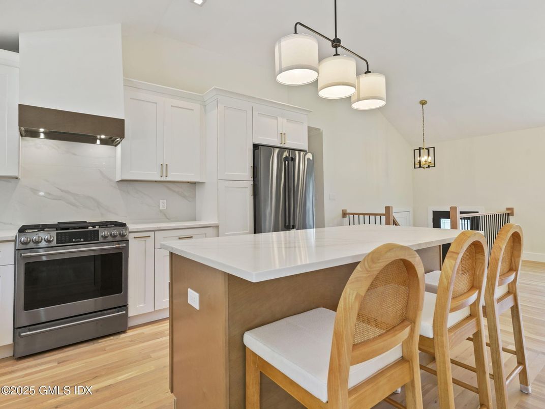 Interior, Kitchen, Marble Walls, Pendant Lights, Stainless Steel Appliances, Wood Texture Flooring