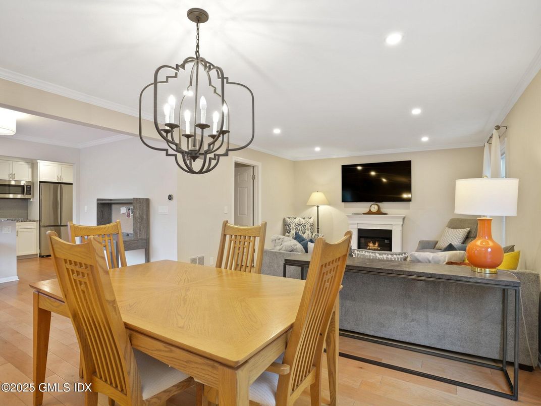 Chandelier, Dining room, Fireplace, Interior, Kitchen, Living room, Recessed Lighting, Stainless Steel Appliances, Wood Texture Flooring