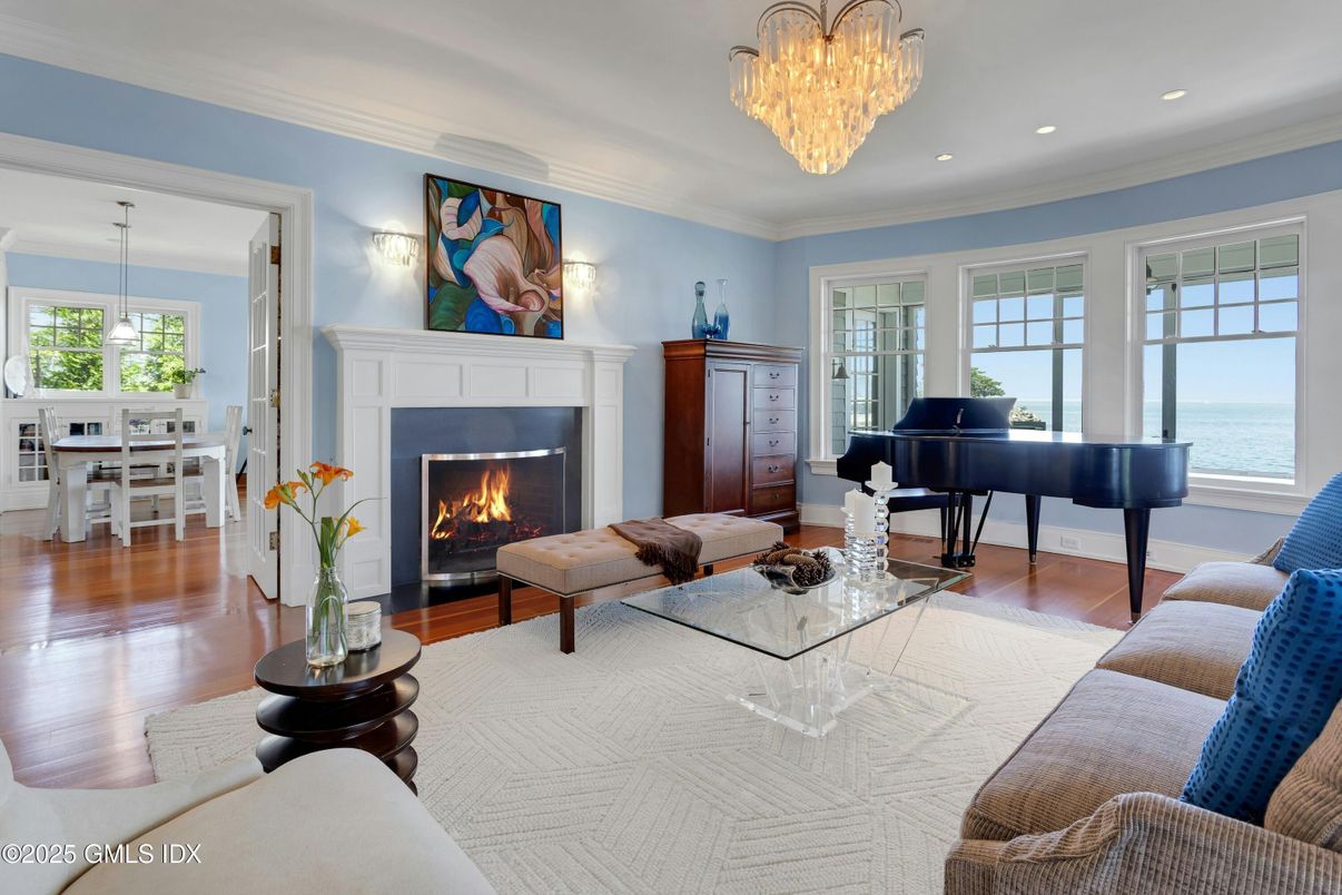 Chandelier, Dining room, Fireplace, Interior, Living room, Piano, Recessed Lighting, Water, Wood Texture Flooring