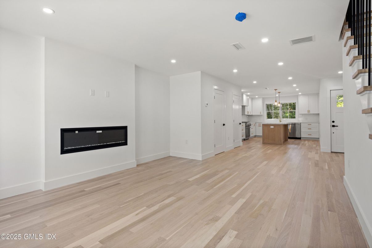 Empty room, Fireplace, Interior, Kitchen, Pendant Lights, Recessed Lighting, Wood Texture Flooring