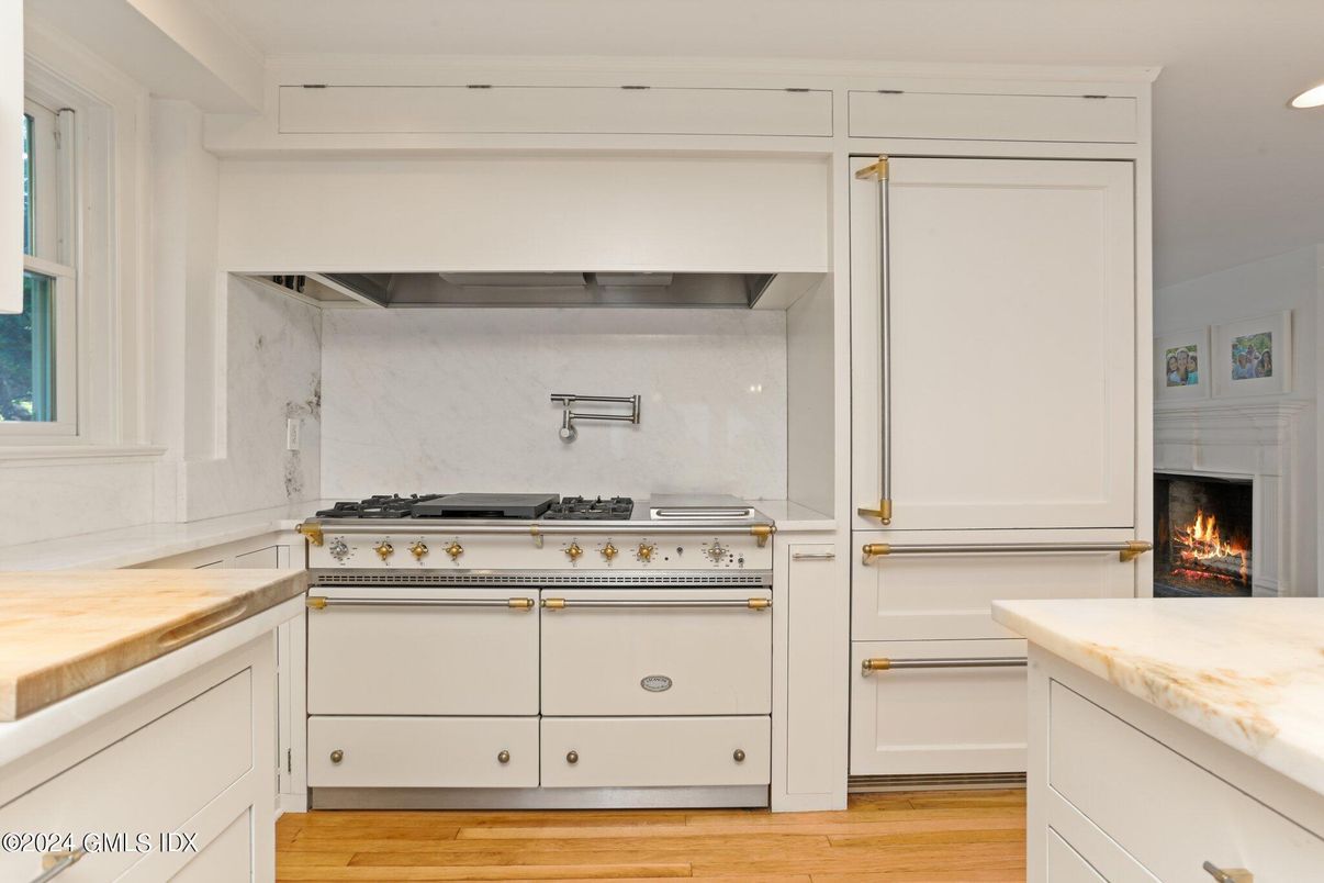 Fireplace, Interior, Kitchen, Marble Walls, Recessed Lighting, Stainless Steel Appliances, Wood Texture Flooring