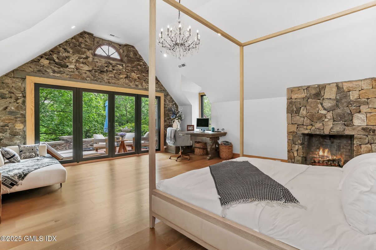 Bedroom, Chandelier, Fireplace, Interior, Recessed Lighting, Stone Walls, Wood Texture Flooring