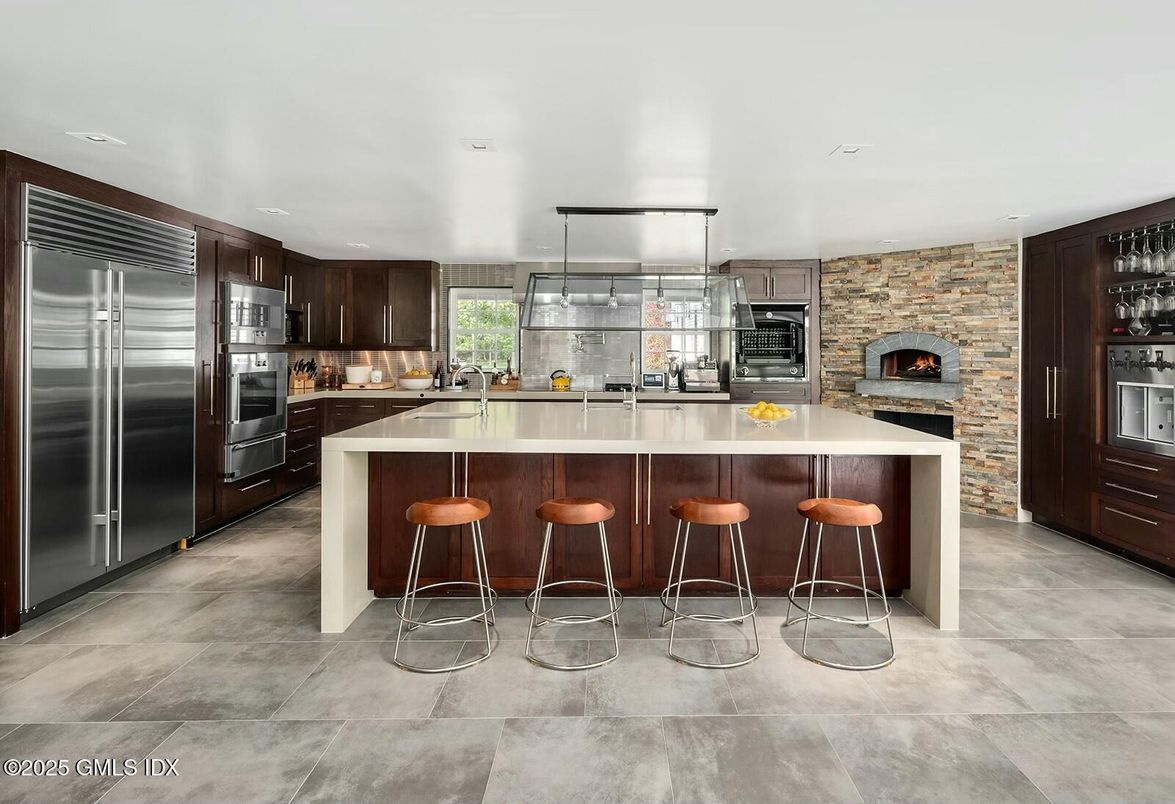 Fireplace, Interior, Kitchen, Recessed Lighting, Stainless Steel Appliances, Stone Walls