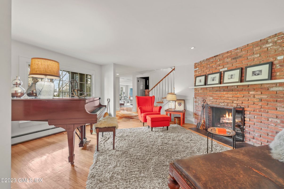 Fireplace, Interior, Living room, Piano, Recessed Lighting, Stone Walls, Wood Texture Flooring