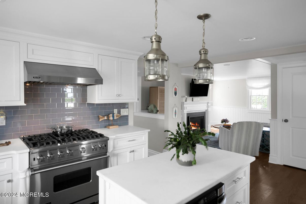 Dining room, Fireplace, Interior, Kitchen, Pendant Lights, Recessed Lighting, Stainless Steel Appliances, Wood Texture Flooring