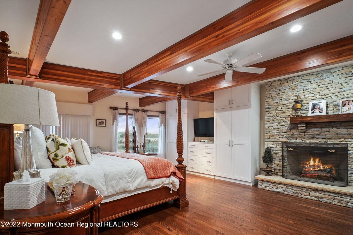 Bedroom, Fireplace, Interior, Recessed Lighting, Stone Walls, Wooden Beams, Wood Texture Flooring