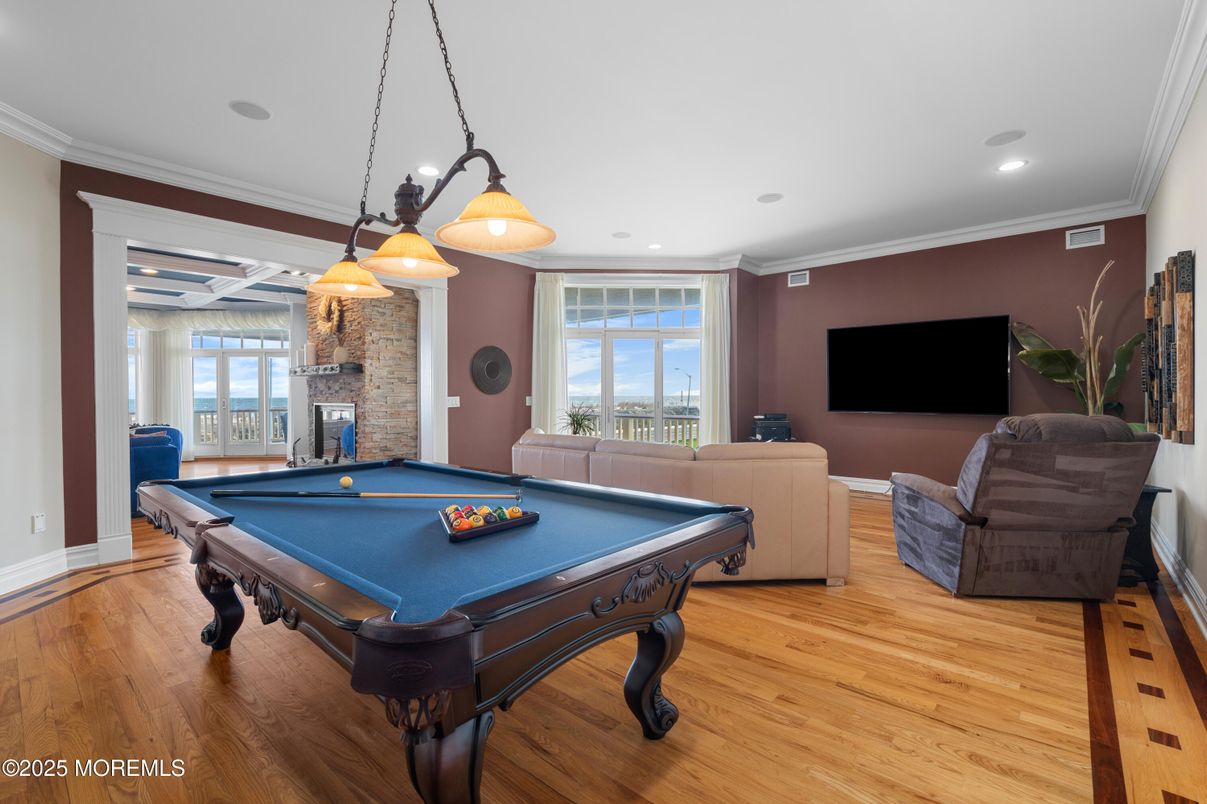 Billiard Table, Fireplace, Game Room, Interior, Pendant Lights, Recessed Lighting, Stone Walls, Wood Texture Flooring