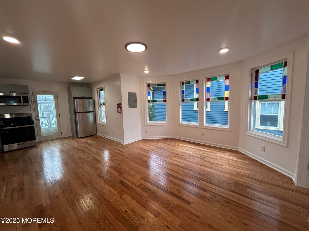 Empty room, Interior, Kitchen, Recessed Lighting, Stainless Steel Appliances, Wood Texture Flooring
