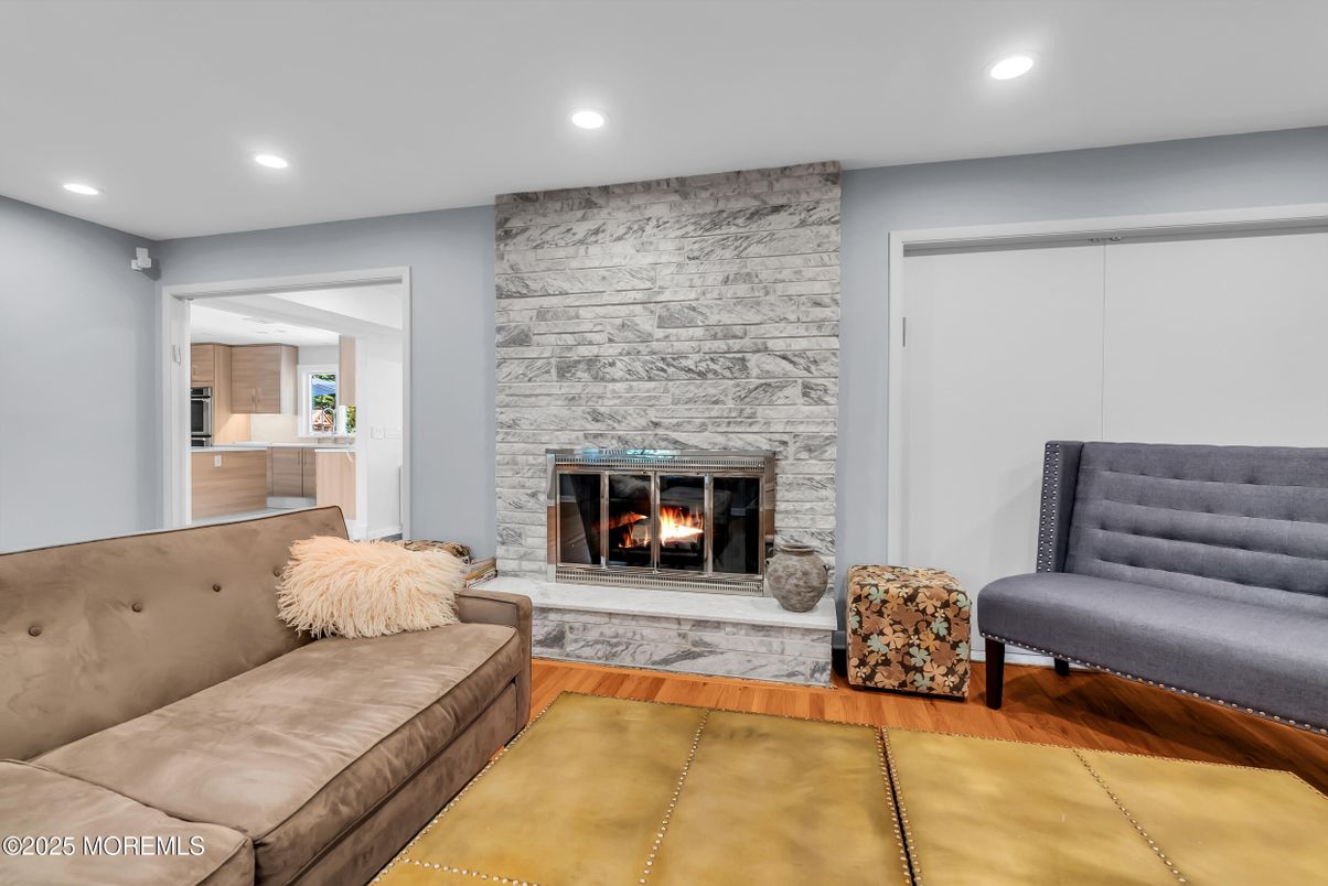 Fireplace, Interior, Living room, Recessed Lighting, Stone Walls, Wood Texture Flooring