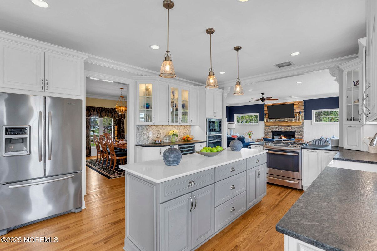 Dining room, Fireplace, Interior, Kitchen, Pendant Lights, Recessed Lighting, Stainless Steel Appliances, Wood Texture Flooring