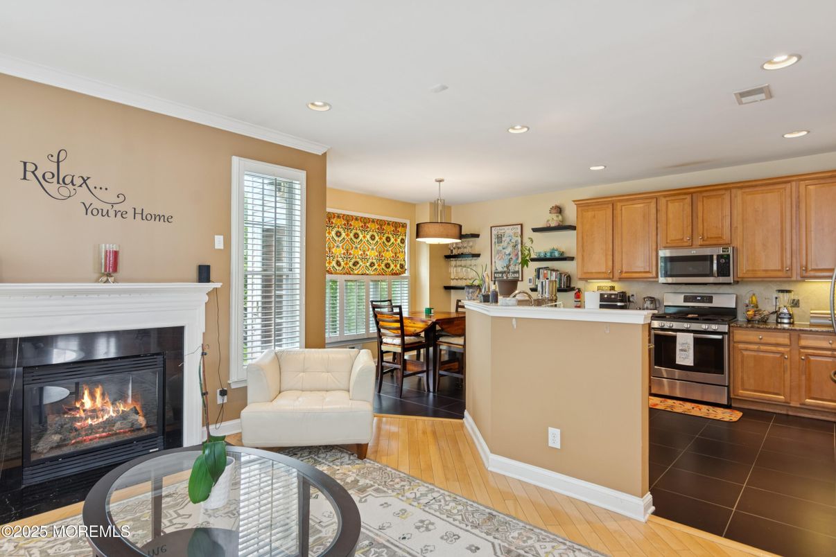 Dining room, Fireplace, Interior, Kitchen, Pendant Lights, Recessed Lighting, Stainless Steel Appliances, Wood Texture Flooring