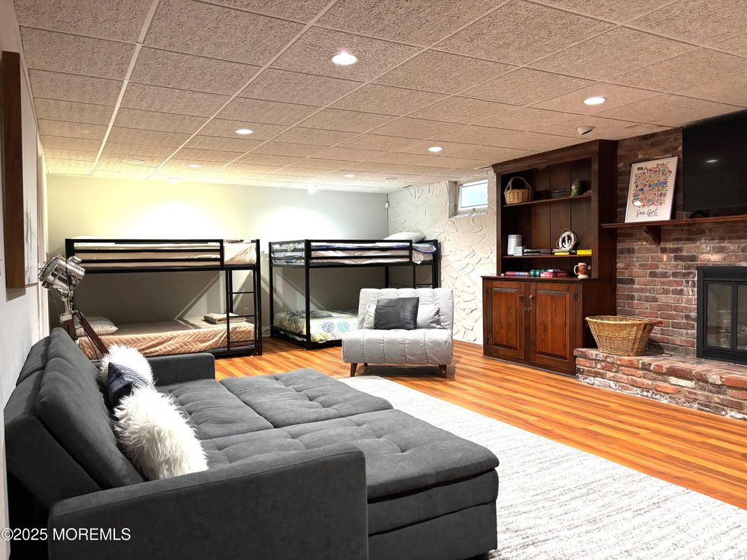 Fireplace, Interior, Living room, Recessed Lighting, Stone Walls, Wood Texture Flooring