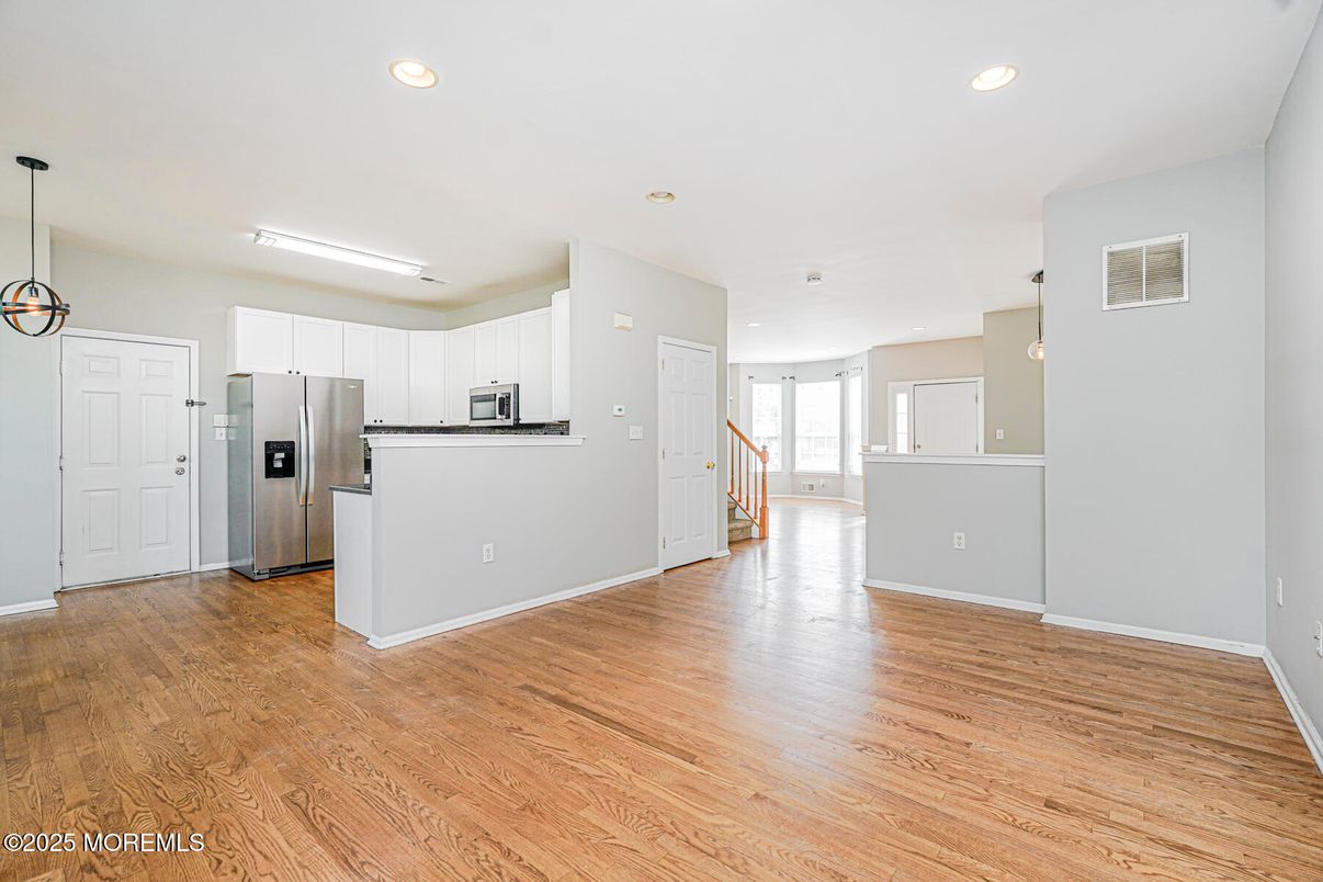 Empty room, Interior, Kitchen, Pendant Lights, Recessed Lighting, Stainless Steel Appliances, Wood Texture Flooring