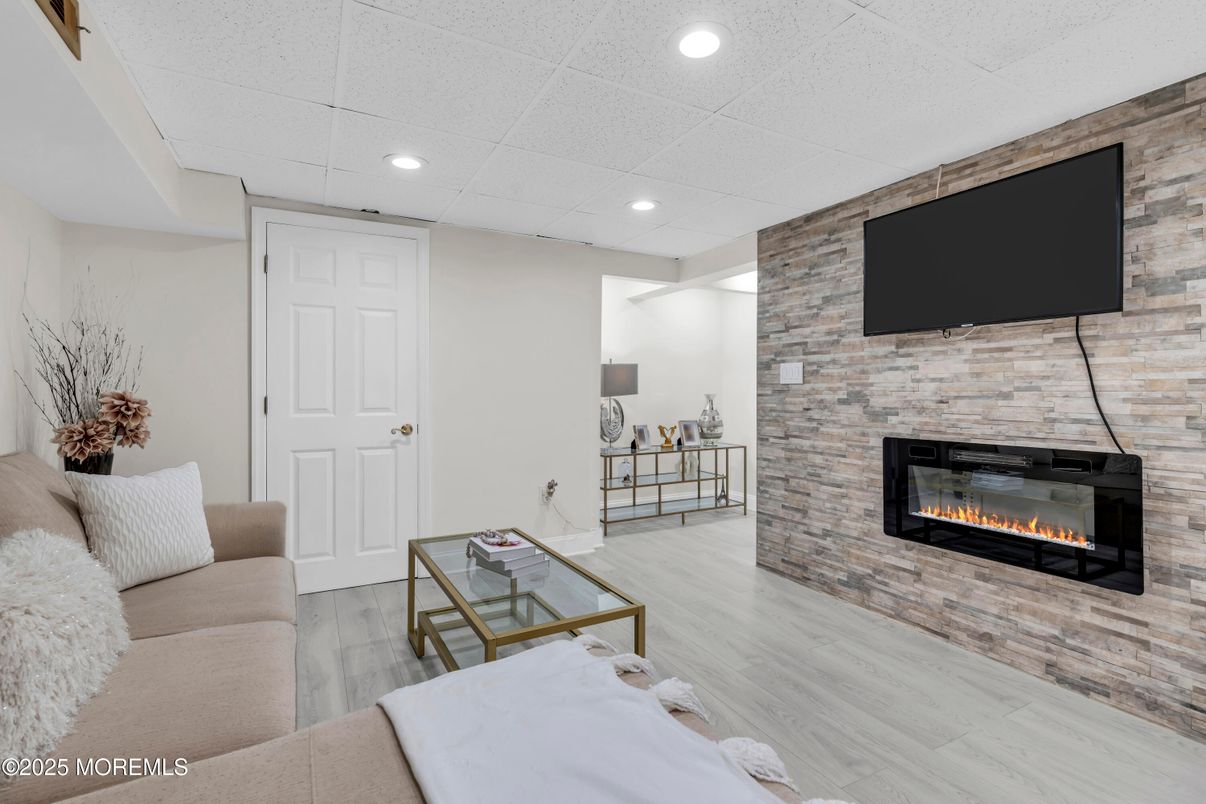 Fireplace, Interior, Living room, Recessed Lighting, Stone Walls, Wood Texture Flooring