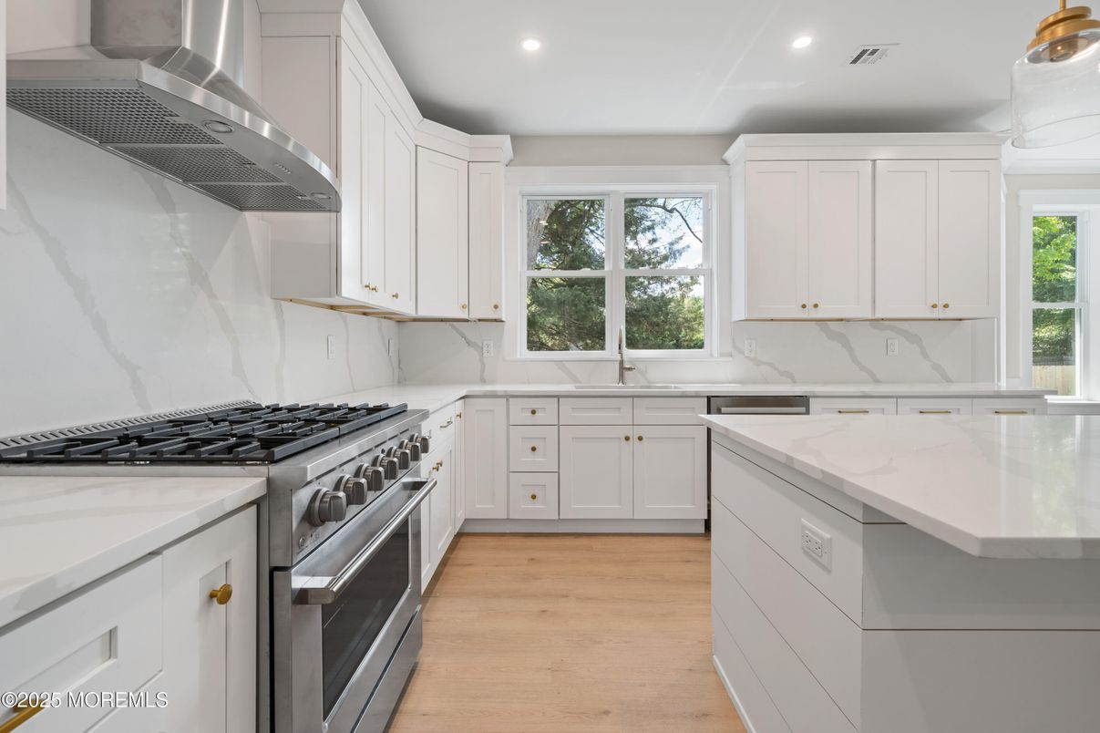 Interior, Kitchen, Marble Walls, Recessed Lighting, Stainless Steel Appliances, Wood Texture Flooring