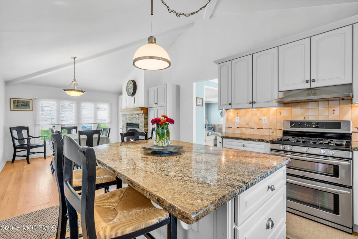 Dining room, Fireplace, Interior, Kitchen, Pendant Lights, Stainless Steel Appliances, Wood Texture Flooring