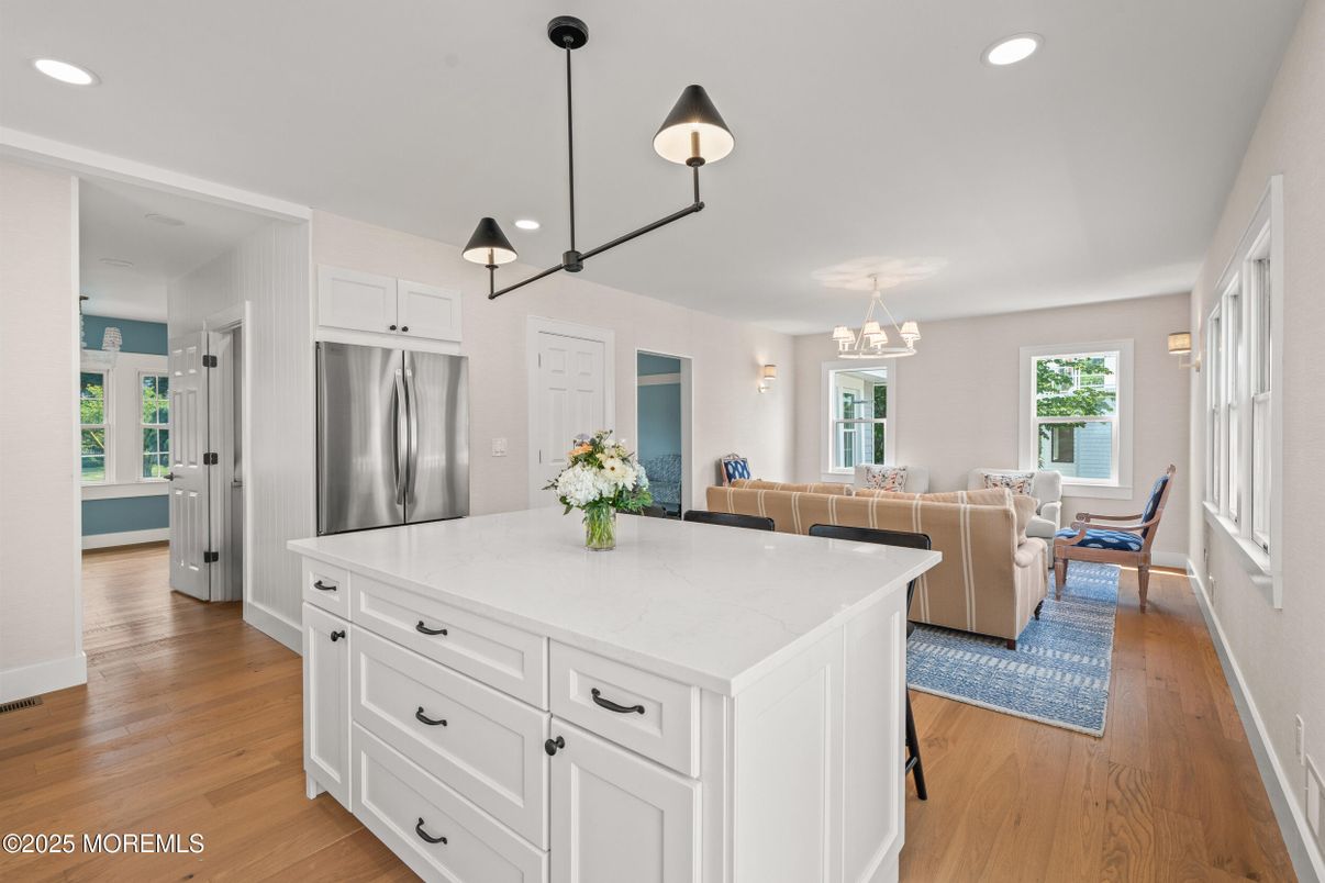 Chandelier, Dining room, Interior, Kitchen, Living room, Pendant Lights, Recessed Lighting, Stainless Steel Appliances, Wood Texture Flooring
