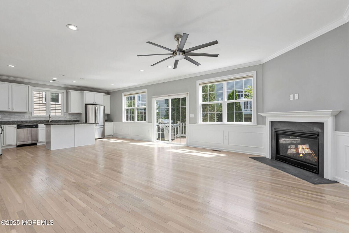 Empty room, Fireplace, Interior, Kitchen, Recessed Lighting, Stainless Steel Appliances, Wood Texture Flooring