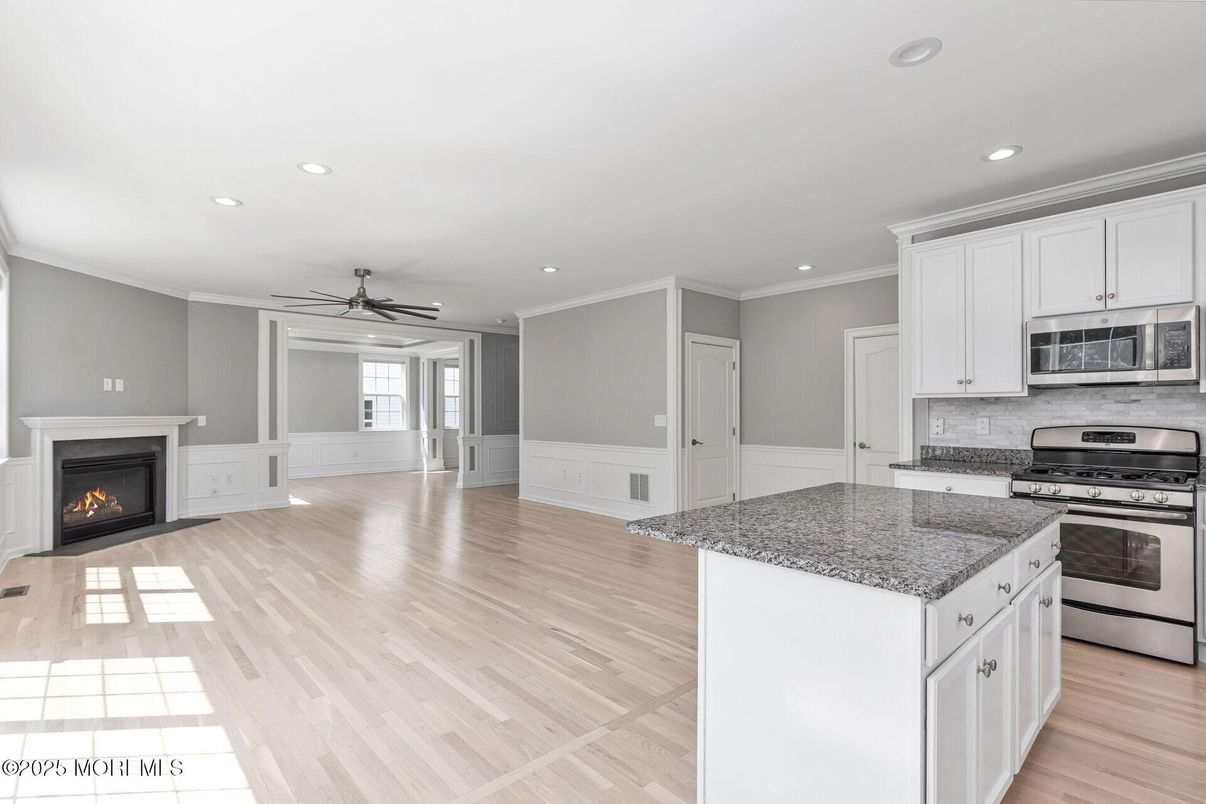 Empty room, Fireplace, Interior, Kitchen, Recessed Lighting, Wood Texture Flooring