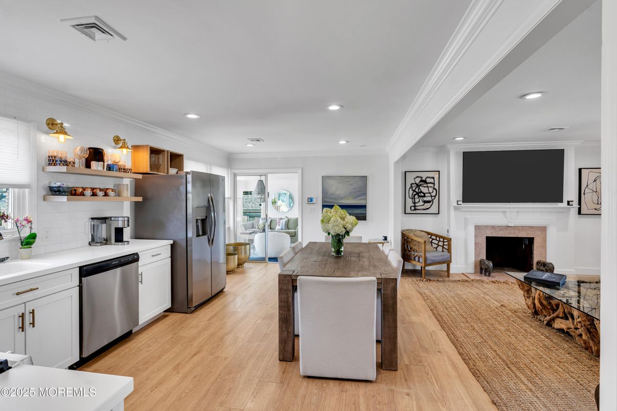 Dining room, Fireplace, Interior, Kitchen, Recessed Lighting, Stainless Steel Appliances, Wood Texture Flooring