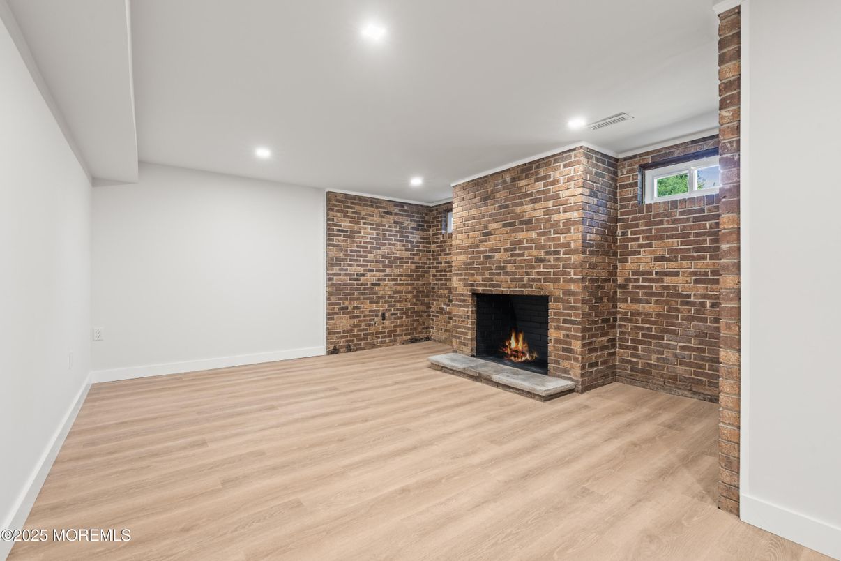 Empty room, Fireplace, Interior, Recessed Lighting, Stone Walls, Wood Texture Flooring