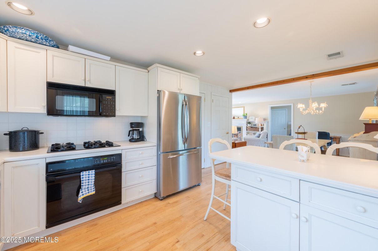 Chandelier, Dining room, Interior, Kitchen, Recessed Lighting, Stainless Steel Appliances, Wood Texture Flooring