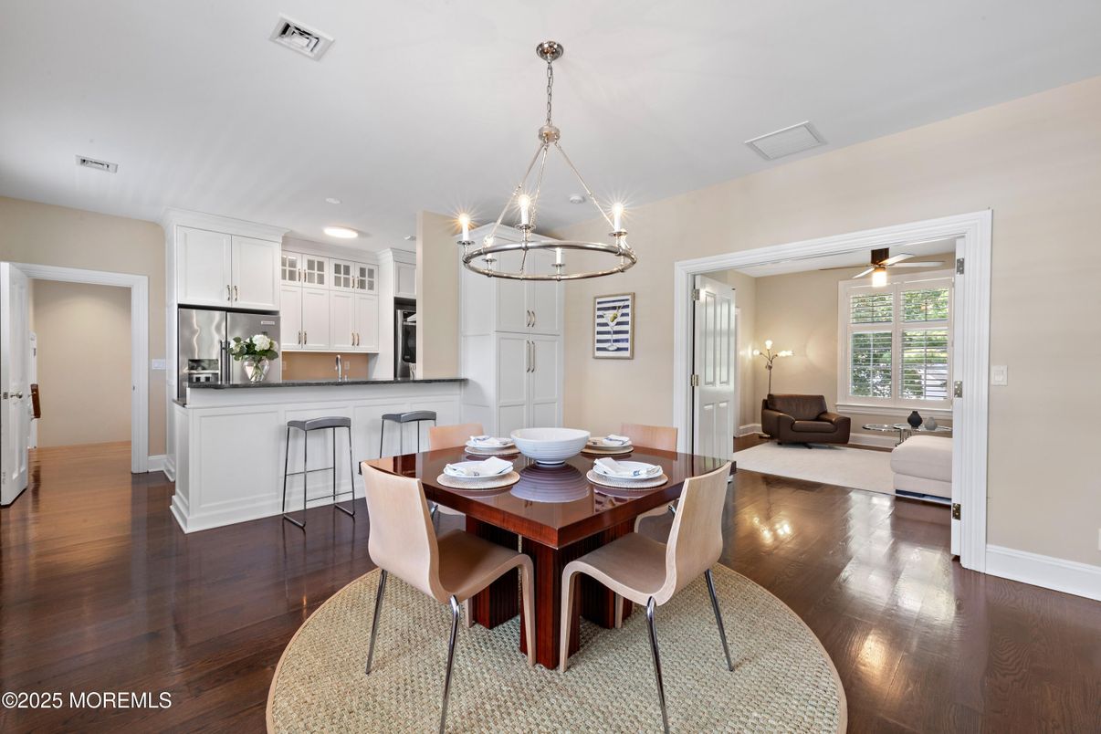 Chandelier, Dining room, Interior, Kitchen, Living room, Pendant Lights, Recessed Lighting, Stainless Steel Appliances, Wood Texture Flooring