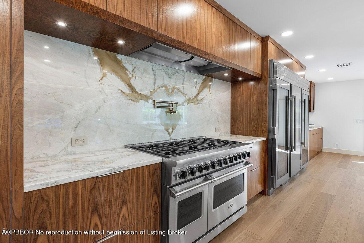 Interior, Kitchen, Marble Walls, Recessed Lighting, Stainless Steel Appliances, Wood Texture Flooring