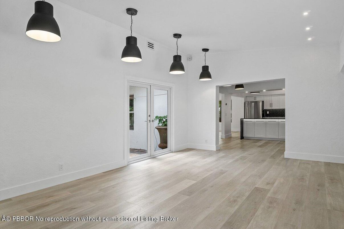 Empty room, Interior, Kitchen, Pendant Lights, Recessed Lighting, Stainless Steel Appliances, Wood Texture Flooring