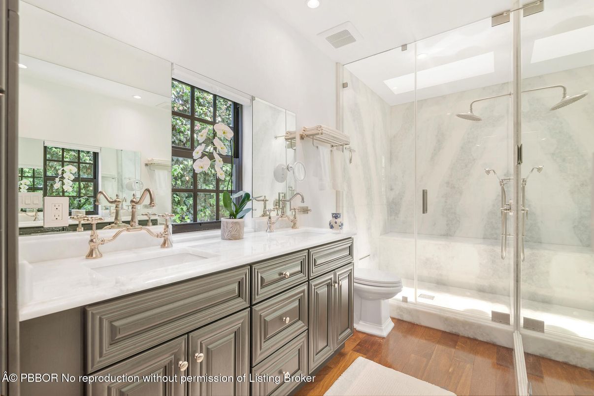 Bathroom, Dual Sink Vanities, Glass Shower, Interior, Marble Walls, Recessed Lighting, Wood Texture Flooring