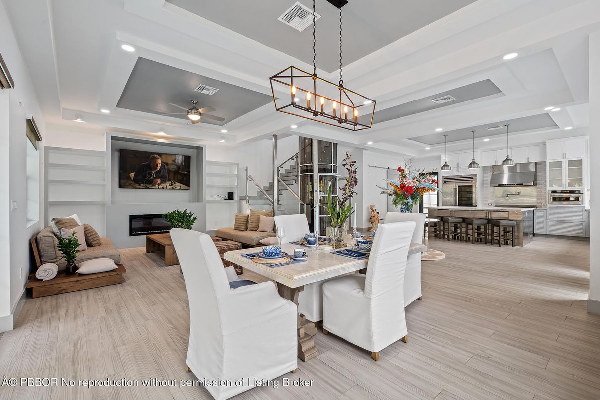 Chandelier, Dining room, Interior, Kitchen, Living room, Pendant Lights, Recessed Lighting, Stainless Steel Appliances, Wood Texture Flooring