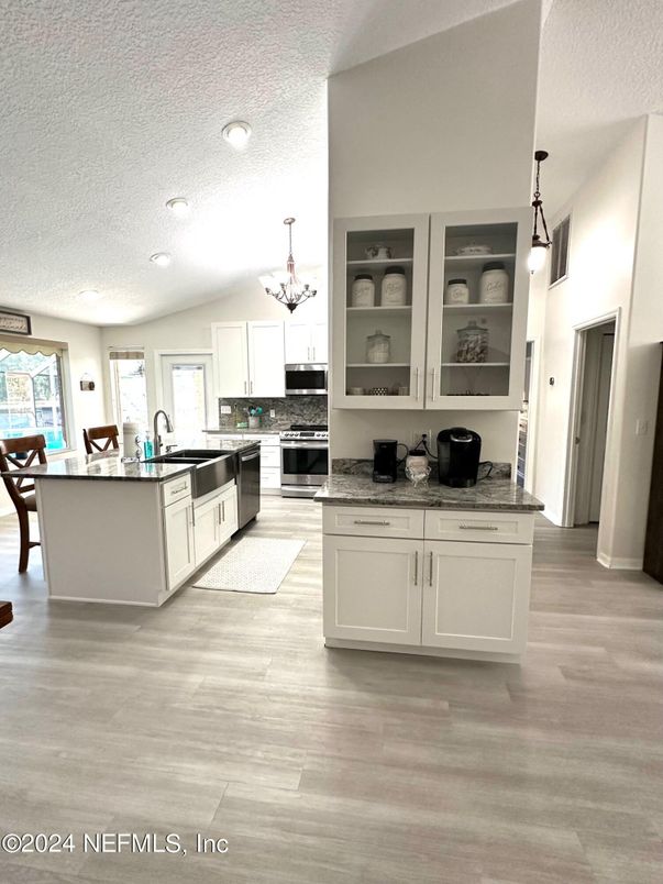 Chandelier, Dining room, Interior, Kitchen, Pendant Lights, Recessed Lighting, Stainless Steel Appliances, Wood Texture Flooring